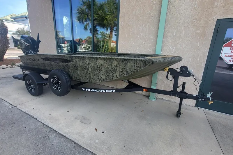 Slide: The Image of 2026 Tracker Grizzly 1650 T Prairie Wings Edition boat on trailer, parked outdoors. - 33