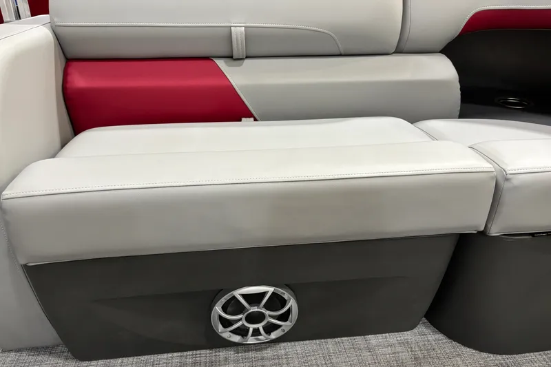 Slide: The Image of 2026 Sun Tracker Party Barge 22 RF DLX seating with red and gray upholstery and speaker. - 17