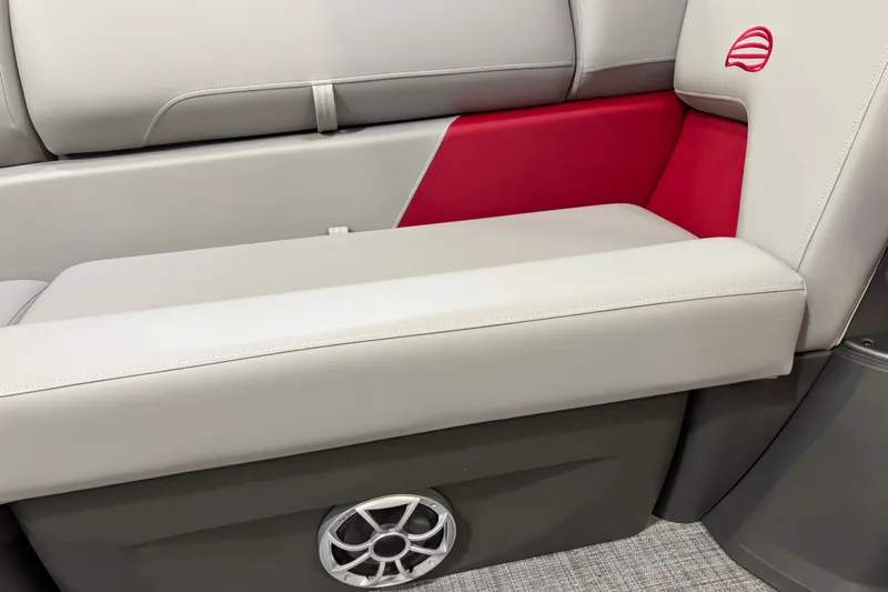 Slide: The Image of 2026 Sun Tracker Party Barge 22 RF DLX seating with red accents and speaker detail. - 18