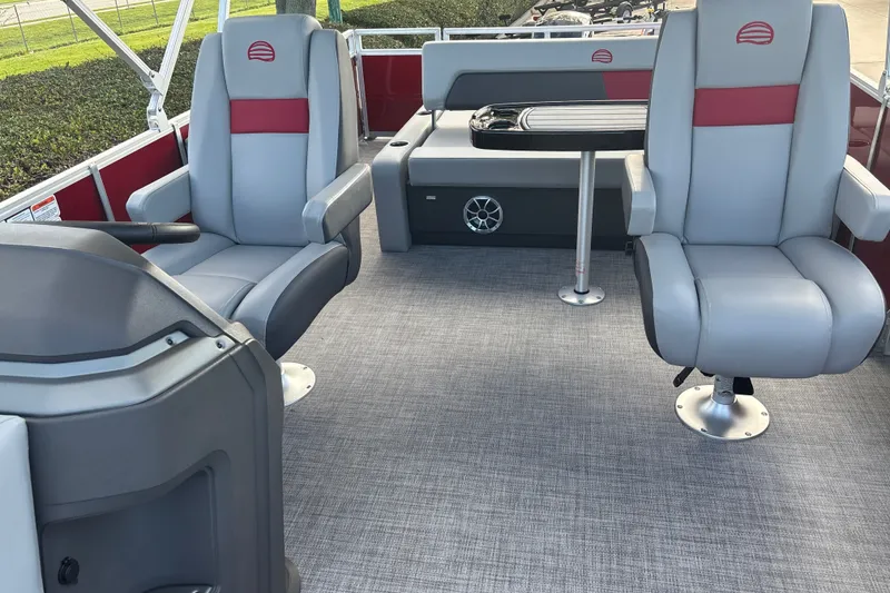Slide: The Image of 2026 Sun Tracker Party Barge 22 RF DLX interior with gray seating and table. - 19