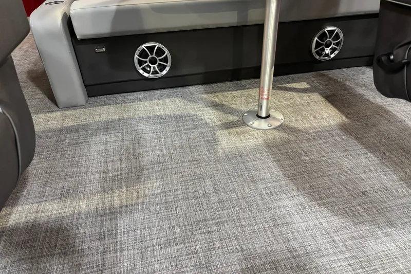 Slide: The Image of Interior of 2026 Sun Tracker Party Barge 22 RF DLX with speakers and textured flooring. - 31