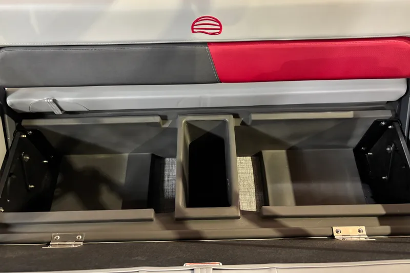 Slide: The Image of 2026 Sun Tracker Party Barge 22 RF DLX storage compartments with red and gray seating. - 40