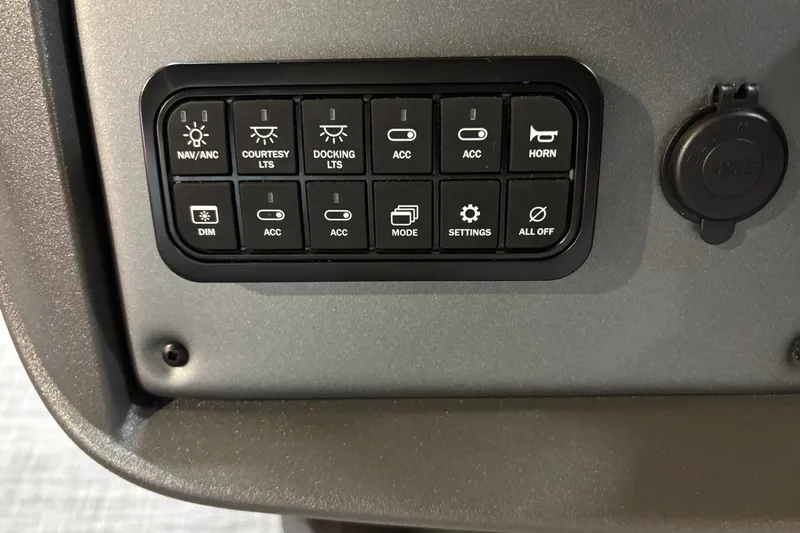 Slide: The Image of Control panel of 2026 Sun Tracker Party Barge 22 RF DLX with various function buttons. - 22