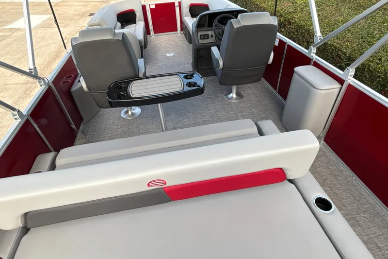 Slide: The Image of 2026 Sun Tracker Party Barge 22 RF DLX interior with seating and helm. - 28