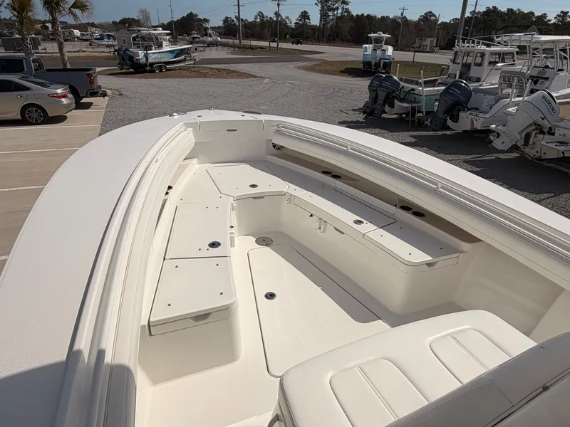Slide: The Image of Regulator 28 boat 2022, spacious deck, parked at a marina. - 12