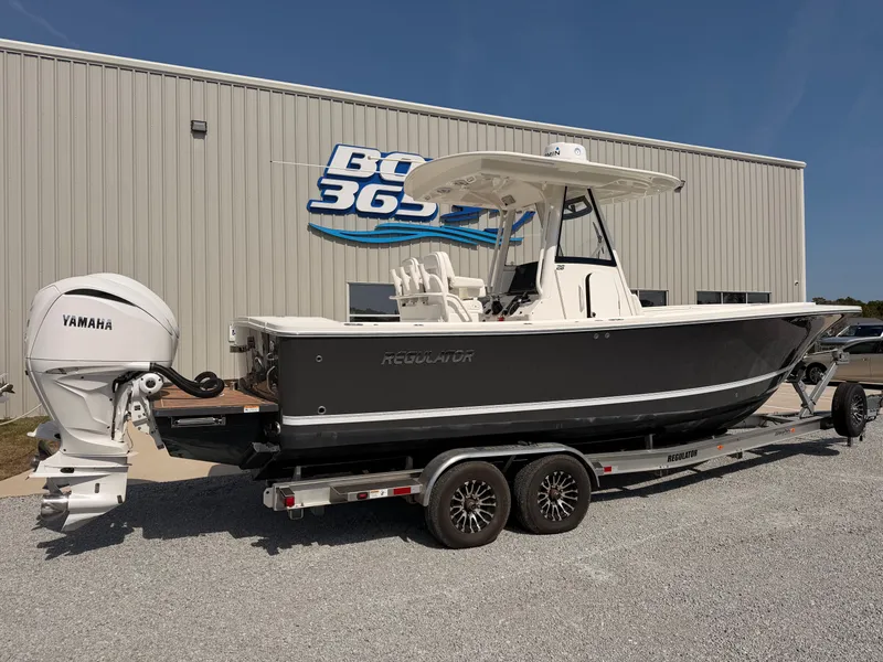 Slide: The Image of 2022 Regulator 28 boat on trailer outside building. - 2
