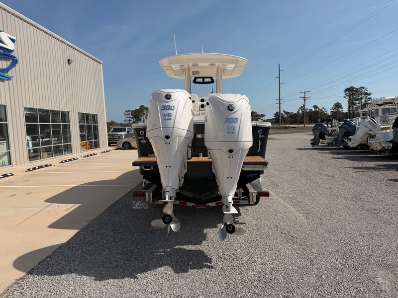 Slide: The Image of Regulator 28 boat 2022 with twin outboard engines on a parking lot. - 3