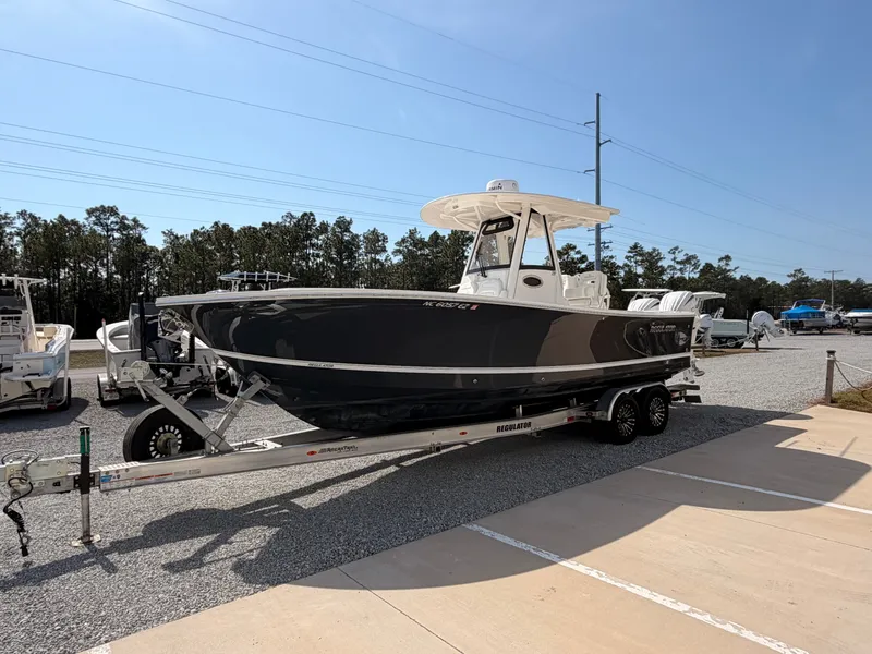 Slide: The Image of 2022 Regulator 28 boat parked on trailer outdoors. - 6
