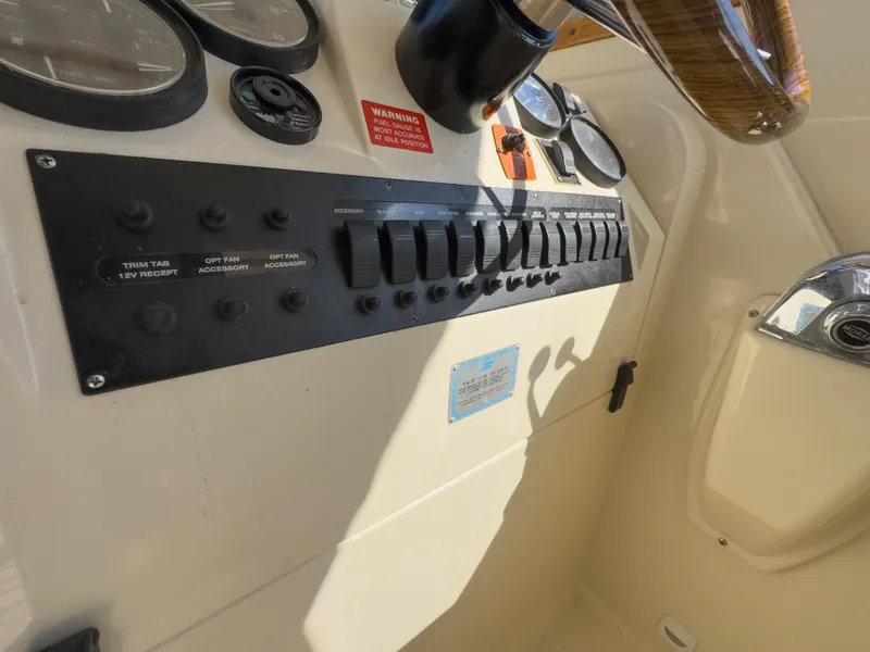 Slide: The Image of Dashboard of a 2004 Mainship Pilot 34 boat with switches. - 10