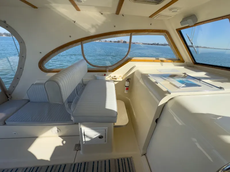 Slide: The Image of Interior of a 2004 Mainship Pilot 34 yacht overlooking the water. - 11