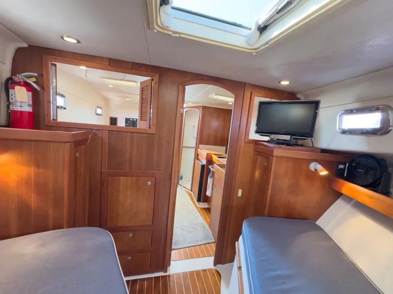 Slide: The Image of Interior of a 2004 Mainship Pilot 34 yacht with wood finish. - 16