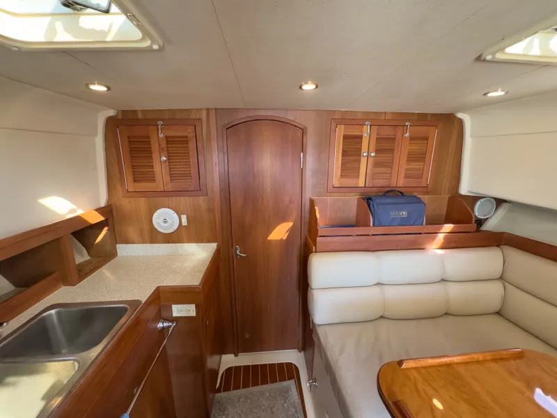 Slide: The Image of Interior of a 2004 Mainship Pilot 34 yacht with wooden furnishings. - 21