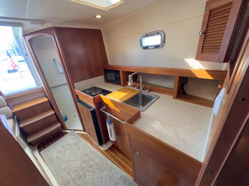 Slide: The Image of 2004 Mainship Pilot 34 boat interior kitchen area. - 23