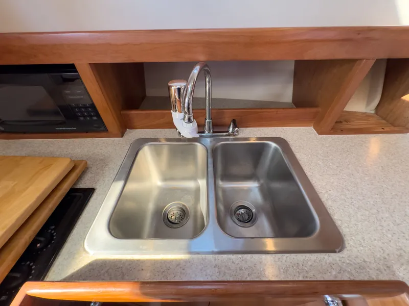 Slide: The Image of Double sink in the kitchen of a 2004 Mainship Pilot 34. - 27