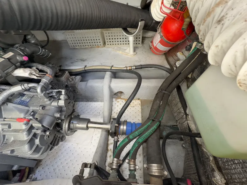 Slide: The Image of Engine room of a 2004 Mainship Pilot 34 with hoses and fire extinguisher. - 40