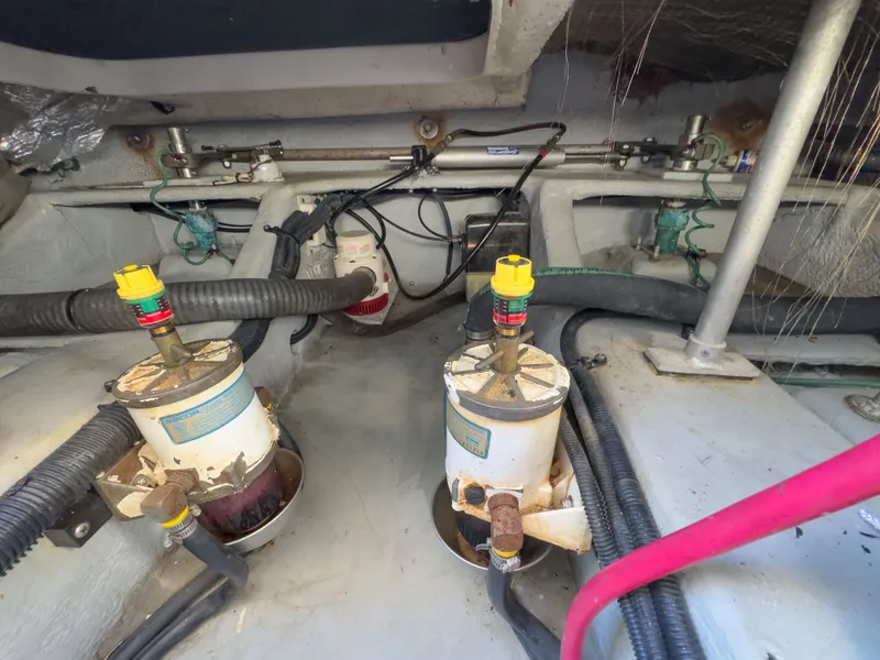 Slide: The Image of Engine room of 2004 Mainship Pilot 34 with hoses and filters. - 42