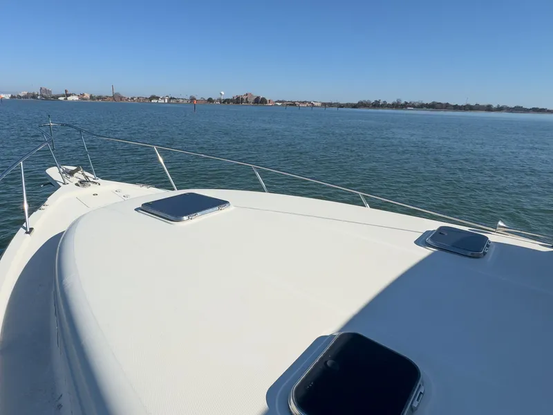 Slide: The Image of Mainship Pilot 34, 2004, on calm water with cityscape in background. - 44