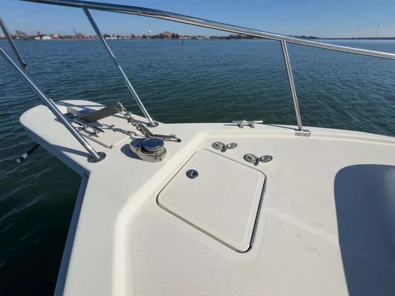 Slide: The Image of Deck of a 2004 Mainship Pilot 34 boat on calm water. - 45