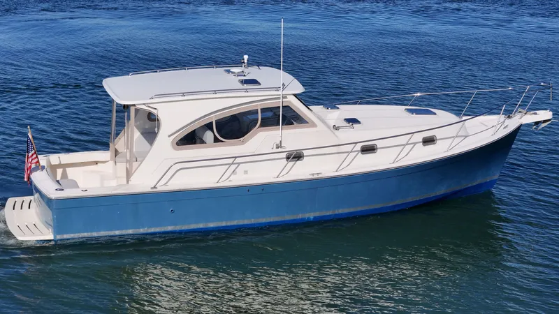 Slide: The Image of 2004 Mainship Pilot 34 on calm water. - 47