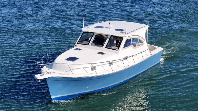 Slide: The Image of 2004 Mainship Pilot 34 boat on calm water. - 48