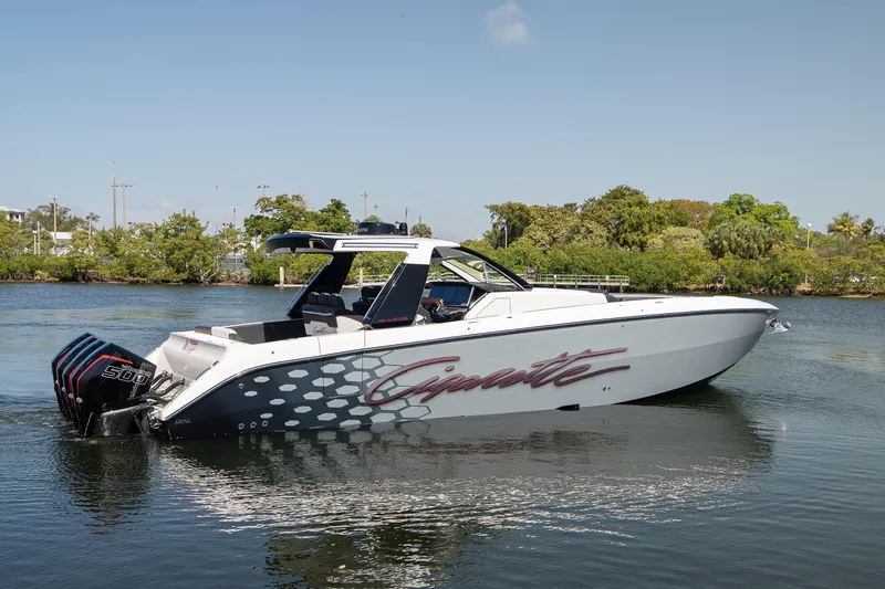 Slide: The Image of 2025 Cigarette 42' Auroris boat on water, showcasing sleek design and powerful engines. - 2