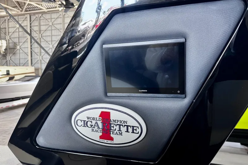 Slide: The Image of 2025 Cigarette 42' Auroris dashboard with Garmin display and racing team emblem. - 21