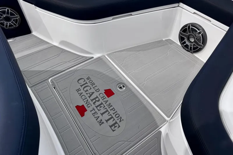 Slide: The Image of 2025 Cigarette 42' Auroris boat interior with branded flooring and speaker. - 25