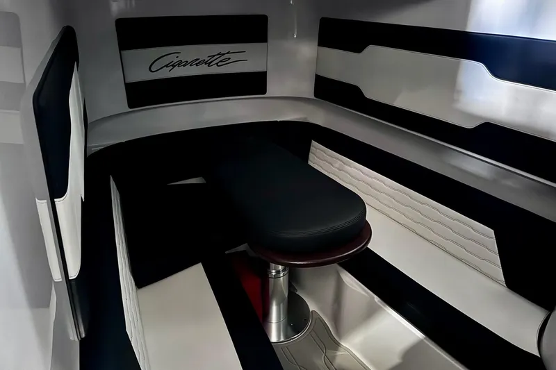 Slide: The Image of Interior of 2025 Cigarette 42' Auroris boat, featuring sleek black and white seating. - 27