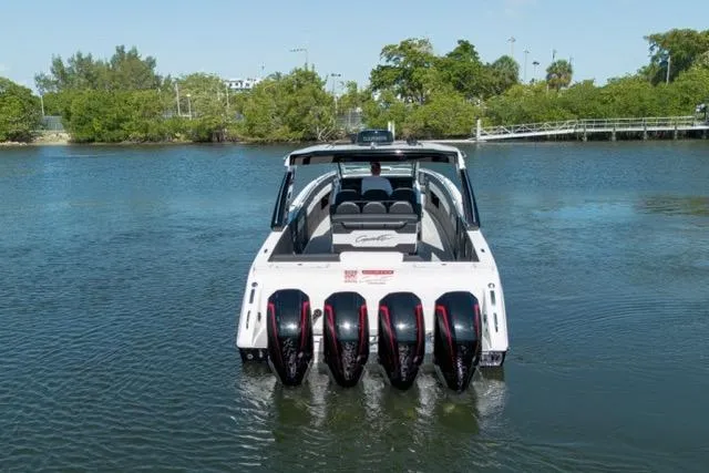 Slide: The Image of 2025 Cigarette 42' Auroris boat with multiple engines on a calm waterway. - 3