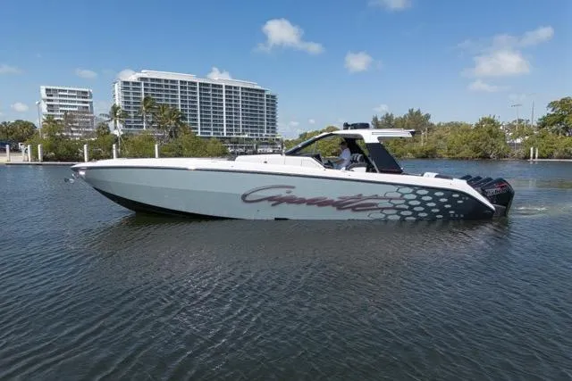 Slide: The Image of 2025 Cigarette 42' Auroris boat cruising on a sunny day near modern buildings. - 6