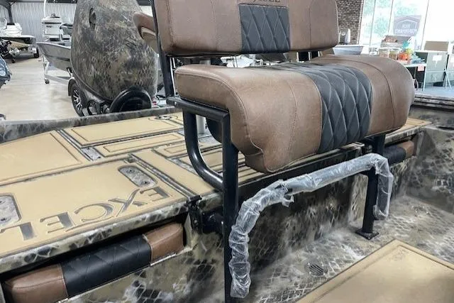 Slide: The Image of 2026 Excel 203 Bay Pro Elite boat interior with cushioned seating and camo design. - 5