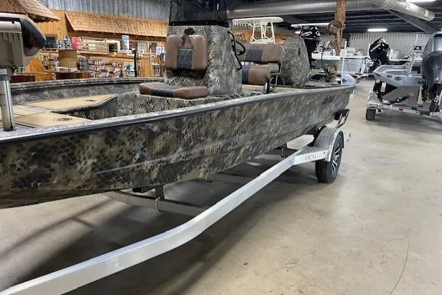 Slide: The Image of 2026 Excel 203 Bay Pro Elite boat with camouflage design on a trailer in a showroom. - 8
