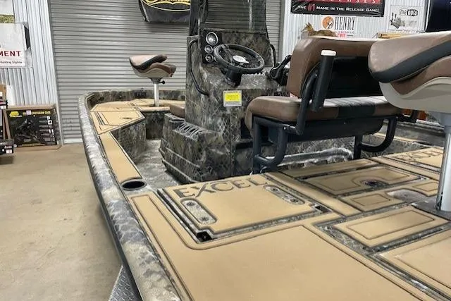 Slide: The Image of 2026 Excel 203 Bay Pro Elite boat interior with camo design and seating. - 9
