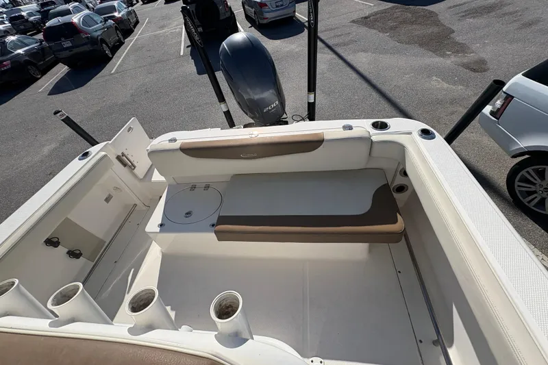 Slide: The Image of 2017 Robalo R222 Center Console boat interior with seating, on calm water. - 9