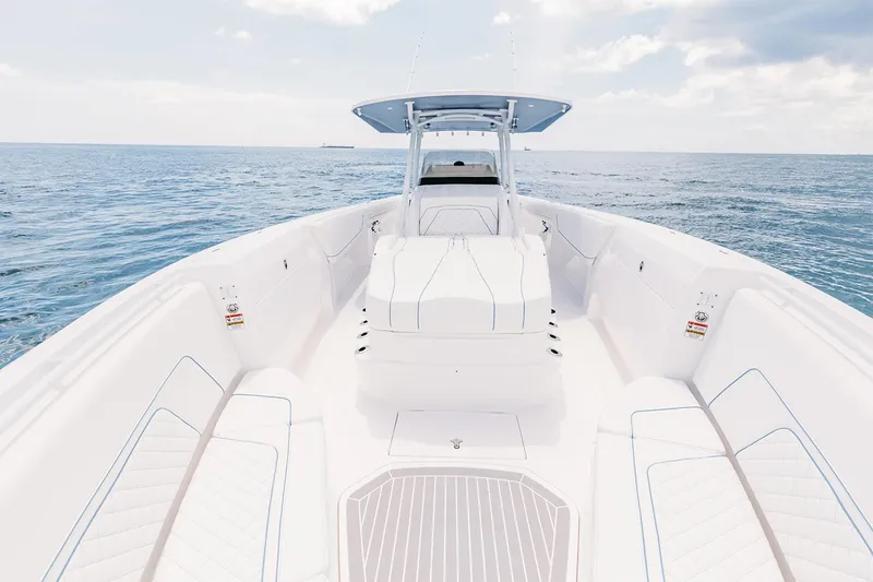Slide: The Image of Manufacturer Provided Image: 2022 Intrepid 407 Nomad FE boat on open water, showcasing spacious deck and seating. - 10