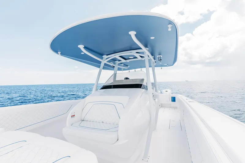 Slide: The Image of Manufacturer Provided Image: 2022 Intrepid 407 Nomad FE boat on open water, featuring a sleek design and spacious deck. - 12