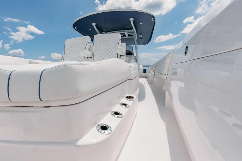 Slide: The Image of Manufacturer Provided Image: 2022 Intrepid 407 Nomad FE luxury boat interior with white seating and blue accents. - 13