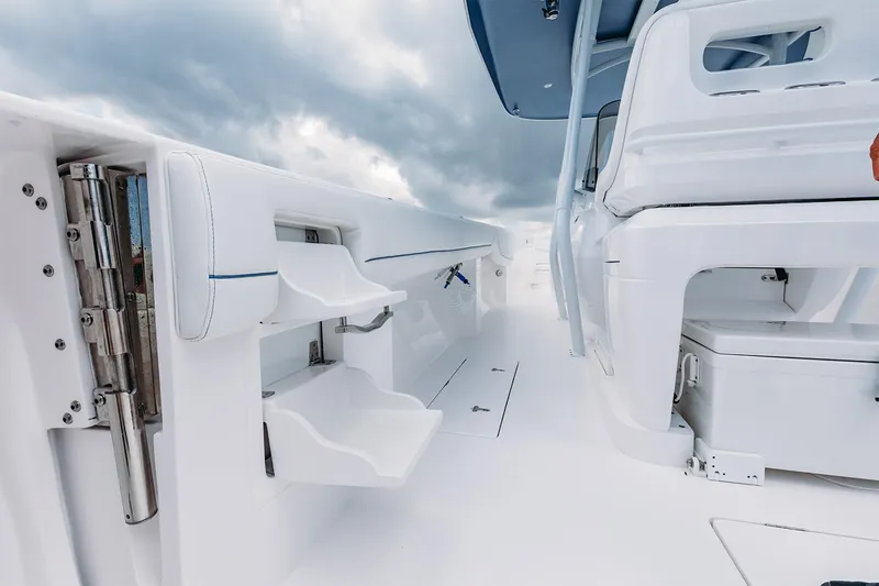 Slide: The Image of Manufacturer Provided Image: 2022 Intrepid 407 Nomad FE boat interior with white seating and storage compartments. - 17