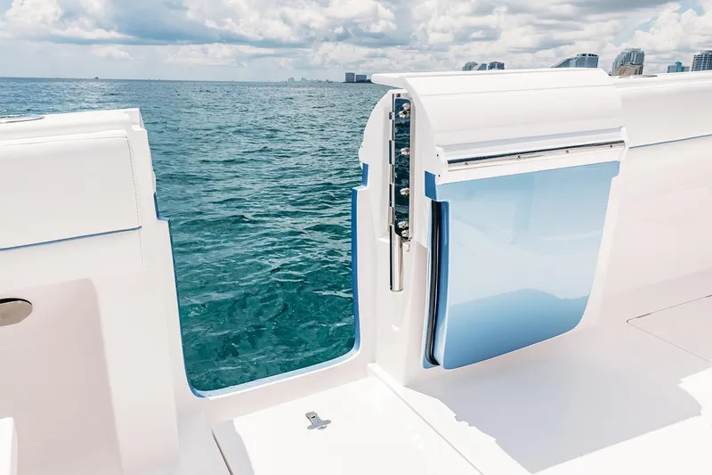 Slide: The Image of Manufacturer Provided Image: 2022 Intrepid 407 Nomad FE boat with open side door on the ocean. - 21
