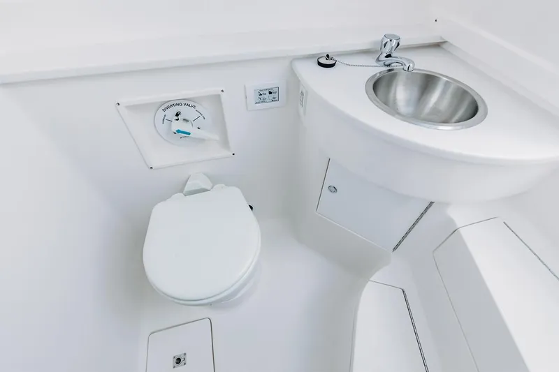 Slide: The Image of Manufacturer Provided Image: 2022 Intrepid 407 Nomad FE boat bathroom with toilet and sink. - 23