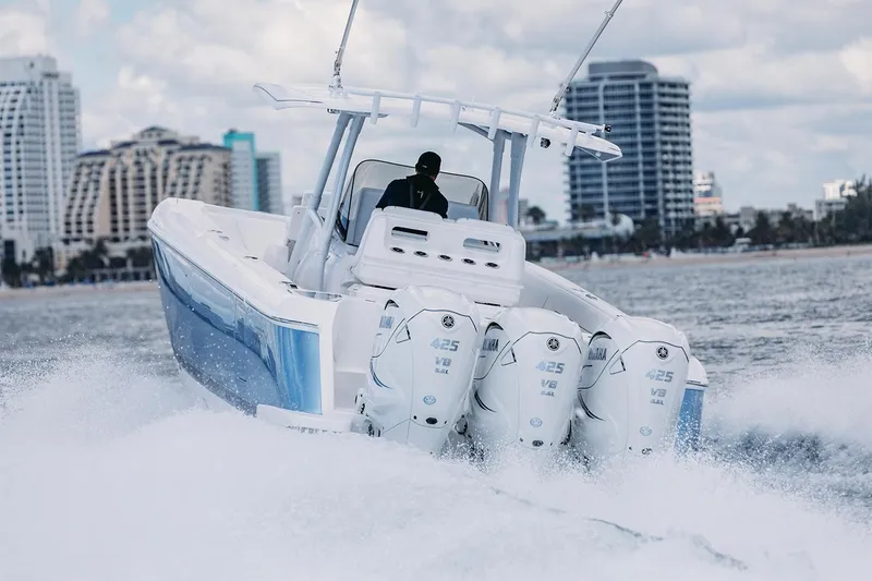 Slide: The Image of Manufacturer Provided Image: 2022 Intrepid 407 Nomad FE boat cruising on water with city skyline in background. - 4