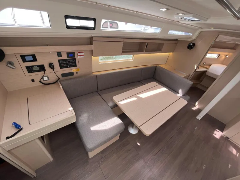 Slide: The Image of 2023 Beneteau Oceanis 40.1 interior with modern seating and navigation area. - 11