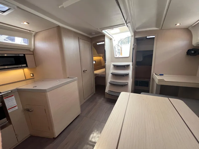 Slide: The Image of 2023 Beneteau Oceanis 40.1 yacht interior with modern kitchen and cozy cabin. - 18