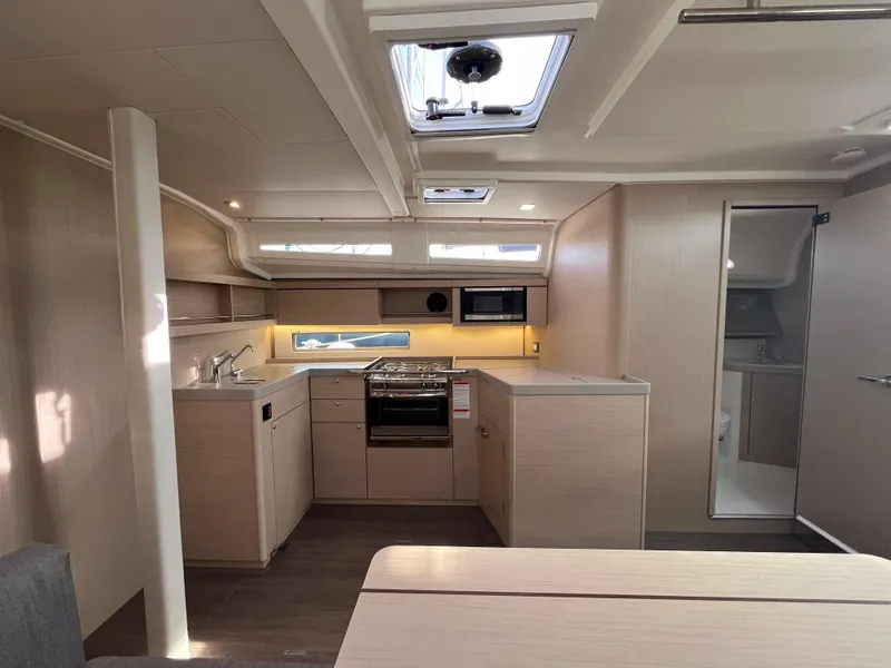 Slide: The Image of 2023 Beneteau Oceanis 40.1 yacht interior with modern kitchen and skylight. - 20