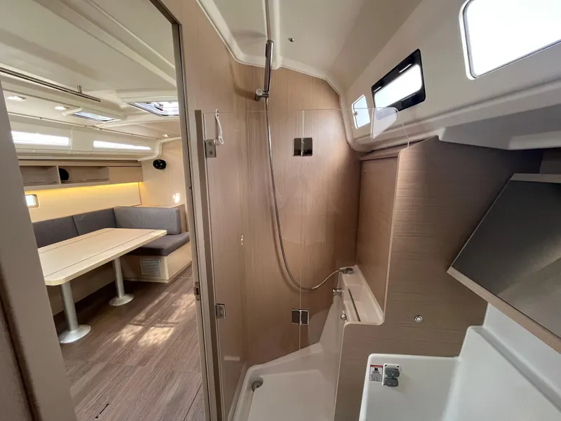 Slide: The Image of Interior of 2023 Beneteau Oceanis 40.1 yacht, featuring modern shower and dining area. - 21