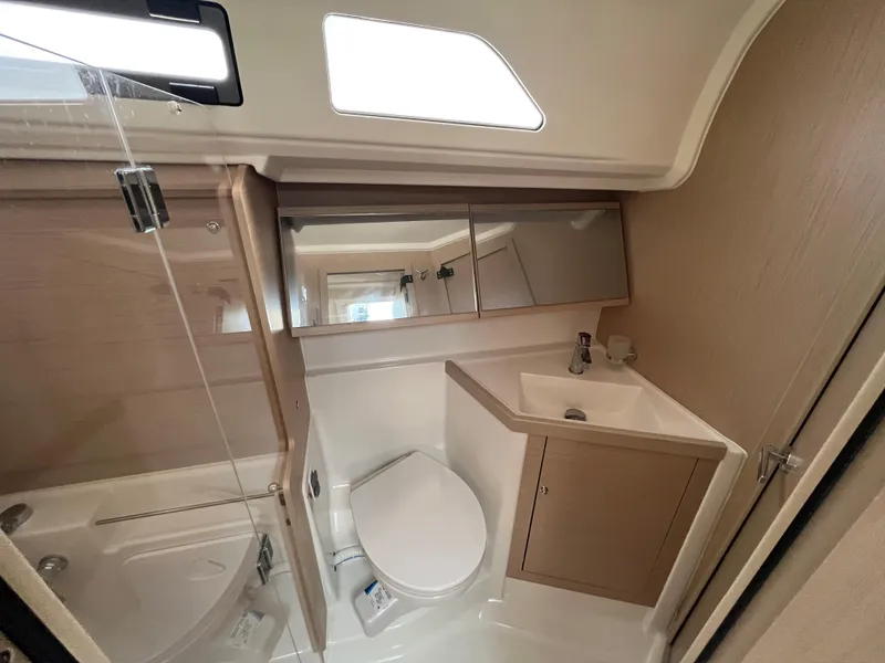 Slide: The Image of Modern bathroom in 2023 Beneteau Oceanis 40.1 yacht with shower, toilet, and sink. - 22