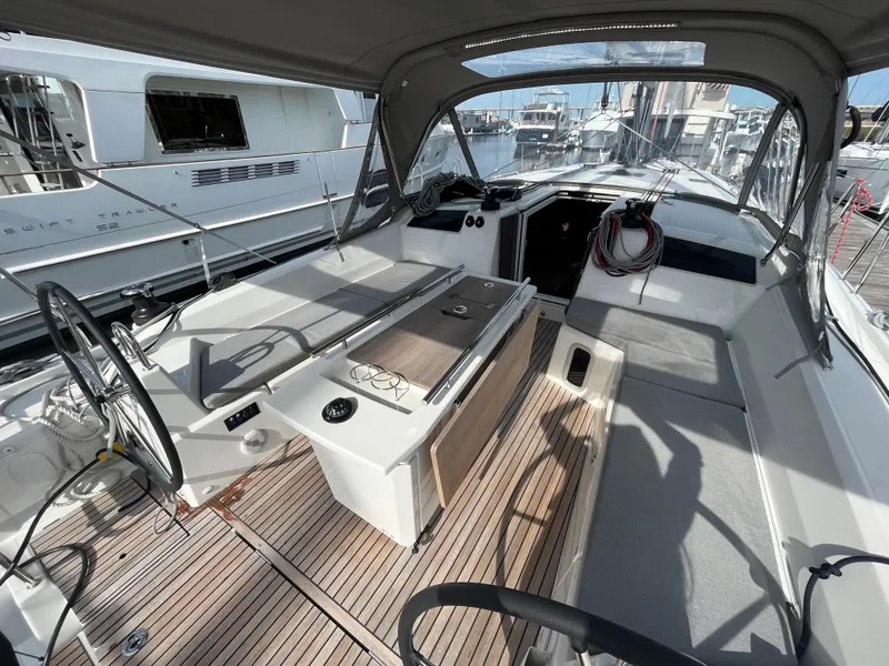 Slide: The Image of 2023 Beneteau Oceanis 40.1 yacht cockpit with teak flooring and modern design. - 7