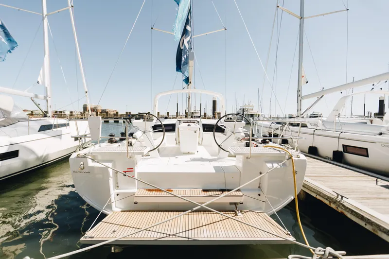 Slide: The Image of 2024 Beneteau Oceanis 46.1 yacht docked at marina, rear view. - 1