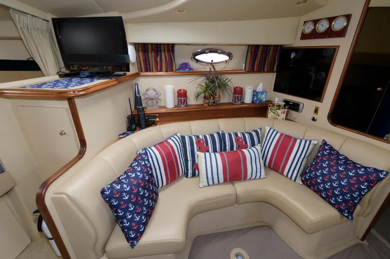 Slide: The Image of Interior of 2002 Cruisers Yachts 3275 Express with nautical-themed decor and seating area. - 10