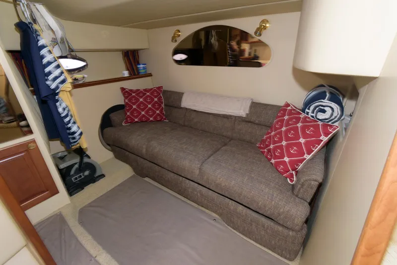 Slide: The Image of Interior of 2002 Cruisers Yachts 3275 Express with sofa and decorative pillows. - 13